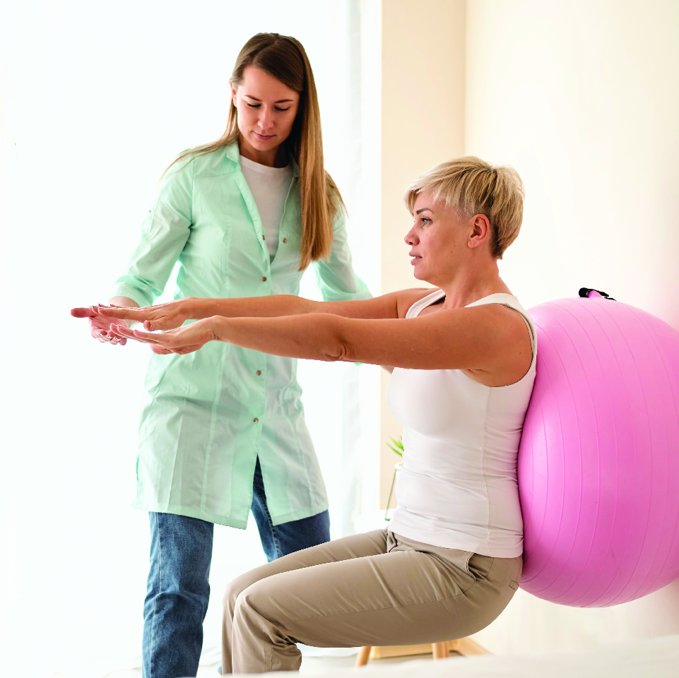 Physiotherapist treating patient at home